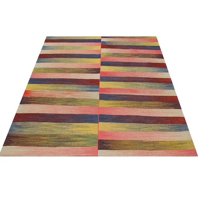 Contemporary Scandinavian Style Kilim area rug featuring a vibrant multi-colored design. Hand-woven from natural wool and...