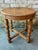 Round wooden side table from France. This wooden end table features a classic "X" base, 4 barley twist style legs, and the...