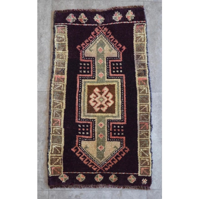 a Vintage Turkish Small yastik rug, dark byzantium color background yastik rug perfect for entryway, bath or in front of...