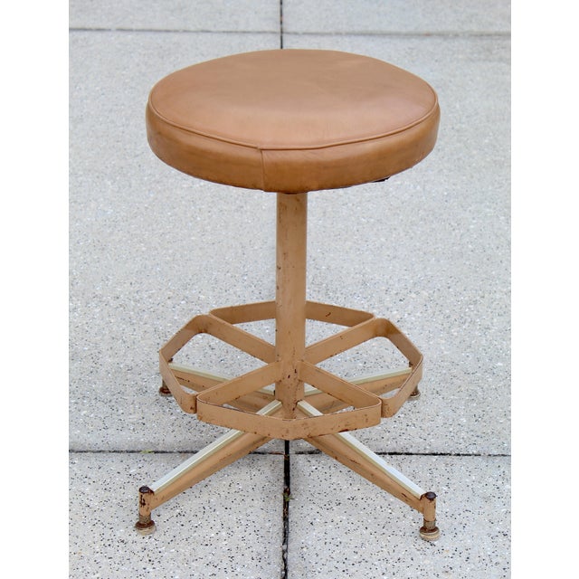 A true slice of functional mid-century design, this vintage swivel stool blends industrial utility with timeless...
