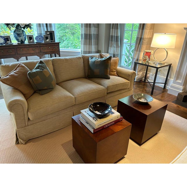 A pair of matching, cube-shaped side or end tables in a book-matched veneer with figured grain, walnut finished wood and...