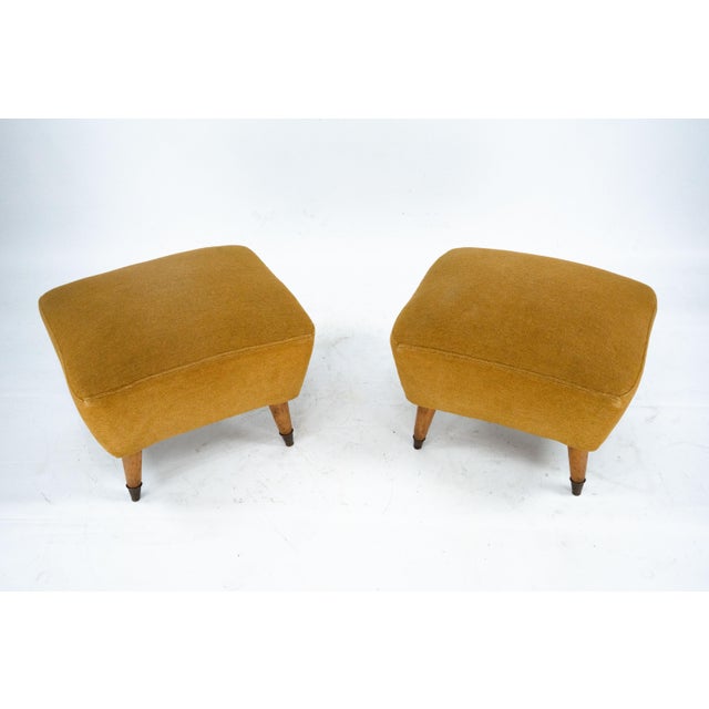 Elegant pair of Italian Mid-Century Modern ottomans dating from the 1950s, in the style of Gio Ponti. Featuring softly...