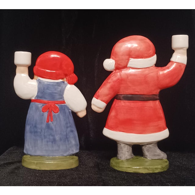 A highly collectible pair of hand-painted porcelain holiday candleholders designed by renowned Swedish ceramicist Lisa...