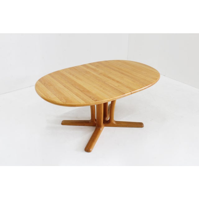 Dyrlund Danish oval extendable dining table made of solid wood from the 1960s by the Danish brand Dyrlund. Thanks to the...