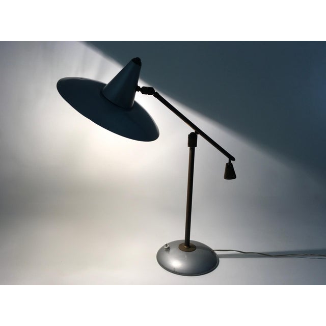 Made in Italy, 1950s. It features a brass and varnished metal structure. This lamp is vintage, therefore it might show...