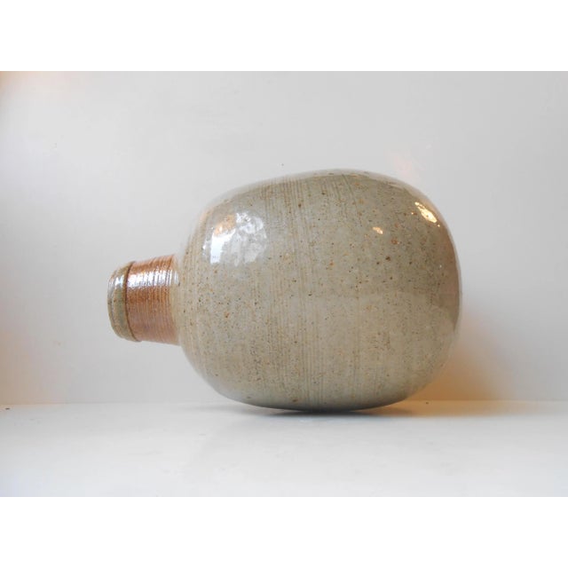 This big vase was designed by Niels Kahler and manufactured by HAK in Denmark during the 1970s. It is made of stoneware...