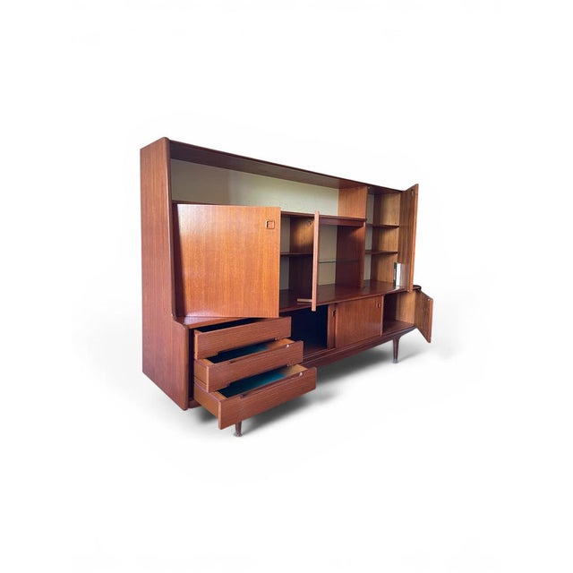 A superb Scandinavian teak veneer set from the 1960s-1970s, comprising a large low sideboard topped with a perfectly...