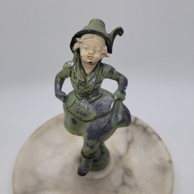 Vintage Art Deco cold painted spelter figure mounted on a natural marble tray. This piece features a character in...