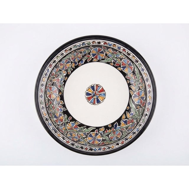 This handcrafted Moroccan tagine originates from the historic artisanal center of Fes. Expertly fashioned from premium...