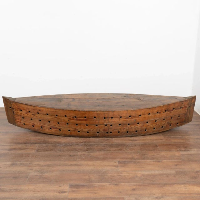 The many holes in this large 7' model boat served a specific purpose; it was used while fishing as a type of oversized...