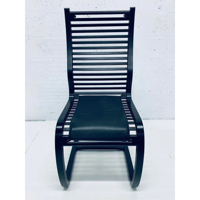 Six ebony stained wood slat cantilevered dining chairs with black Naugahyde cushions designed by Terje Hope for Westnofa,...