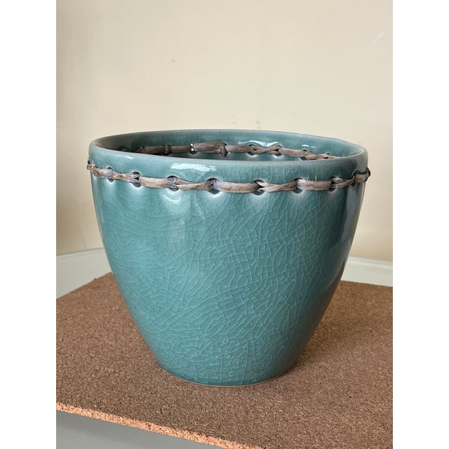 Dark Teal ‘crazed’ glazed ceramic pot with flat woven rattan collar. Dark teal tone with no nicks, scratches or damaged...