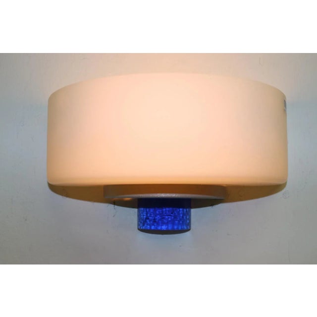 Modern Wall Lamp Murano White Glass Sating Finish and Blue Cast Glass Accent. Gray Lacquered Metal Mounting. Designed by...
