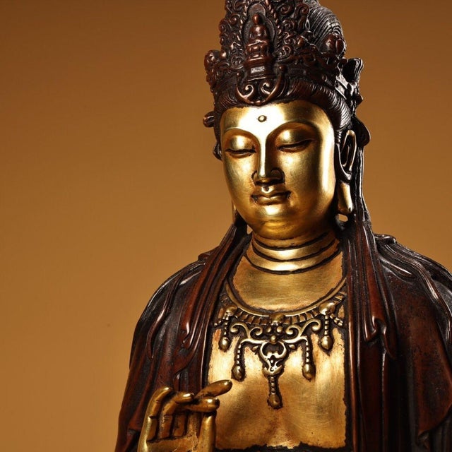 This elegant sculpture depicts a seated Guanyin Bodhisattva, the embodiment of compassion. The figure is crafted from...
