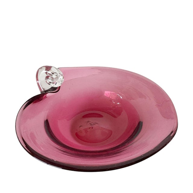 A stunning Italian art glass dish. Shaped like a heart and in a rich, deep pink. It features a beautifully crafted clear...