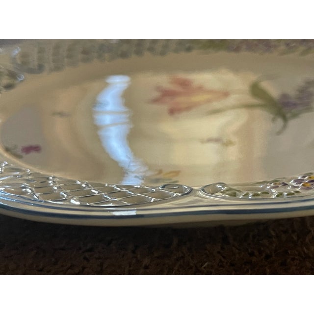 Hand-painted decorative plate with floral motif and 'laced' edge by Anna Weatherley, a designer known for her exquisite...