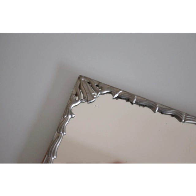 Small square shaped vintage Swedish Modern Pewter Mirror with decorative organic flower and leaf decoration around the...