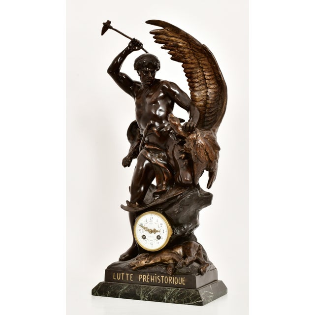 An exceptional Antique French patinated bronze figural sculpture clock titled Lutte Préhistorique ("Prehistoric...
