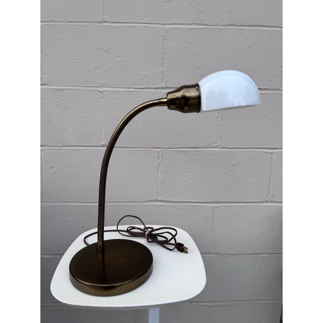 A beautiful example of mid-century American task lighting that's as functional as it is good-looking. This brass gooseneck...