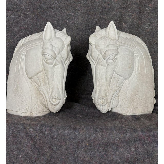 A rare pair of muscular architectural horse head sculptures cast in exceptionally dense, fine concrete—far heavier and...