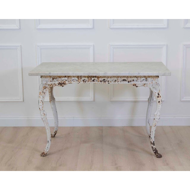 19th Century French Painted Iron Table witAn elegant 19th century French painted iron table featuring graceful cabriole...