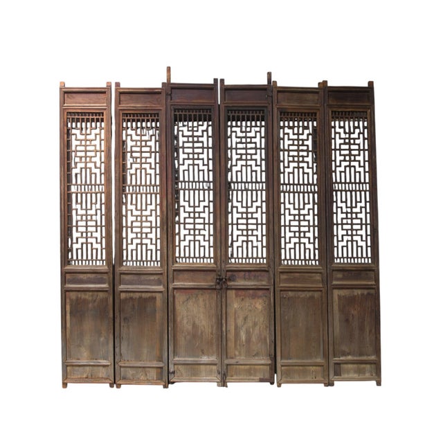 This 6 panel set of antique Chinese screen doors showcases a blend of traditional craftsmanship through its intricately...