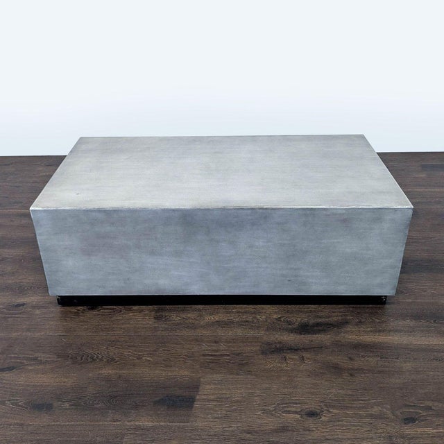 Faux concrete plinth table. Brand: Pottery Barn. Dimensions (in): 50W x 26D x 17H.