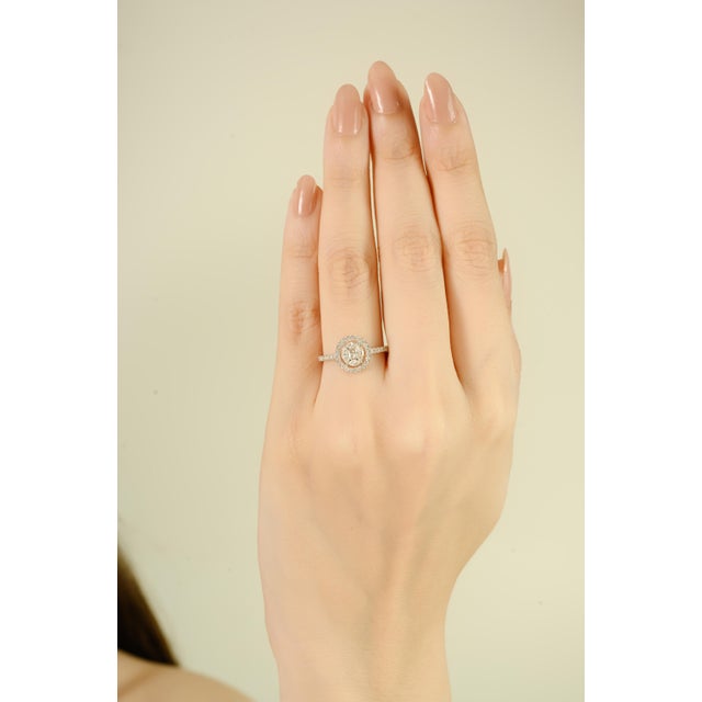 Elegant estate engagement ring crafted in 14k white gold, featuring round brilliant-cut diamonds weighing 0.65 carats. The...