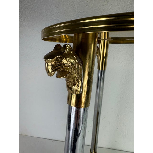 This is a vintage glamorous brass and chrome martini table. This martini table has brass feet that are cast in the form of...