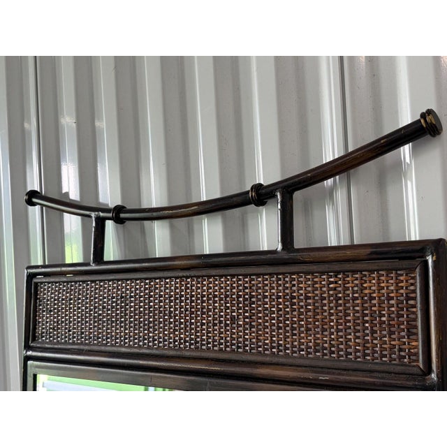 This is a unique mirror done in the Asian style. It features both iron and wicker/ rattan woven. The top is a pagoda. This...