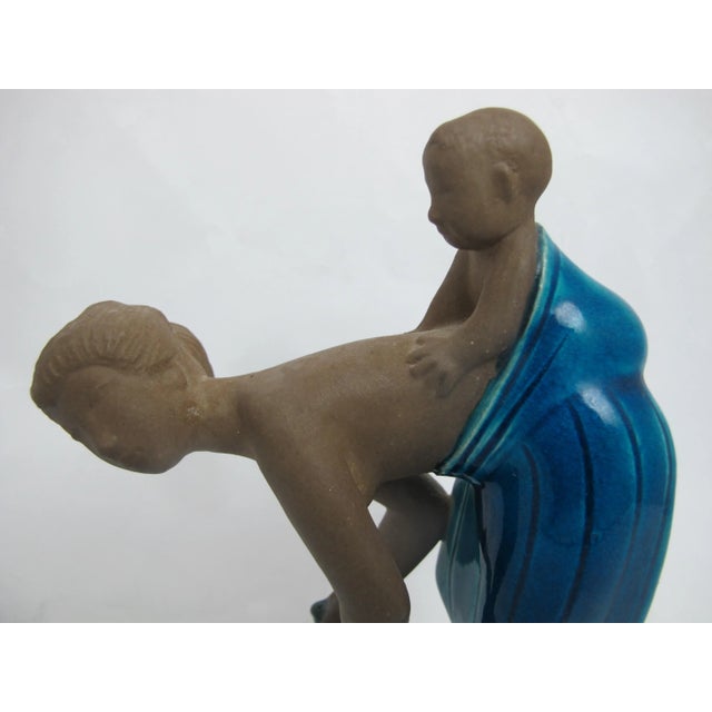 Royal Copenhagen Figurine 21565 by Johannes Hedegaard. Beautifully modelled figurine of young woman doing her washing with...