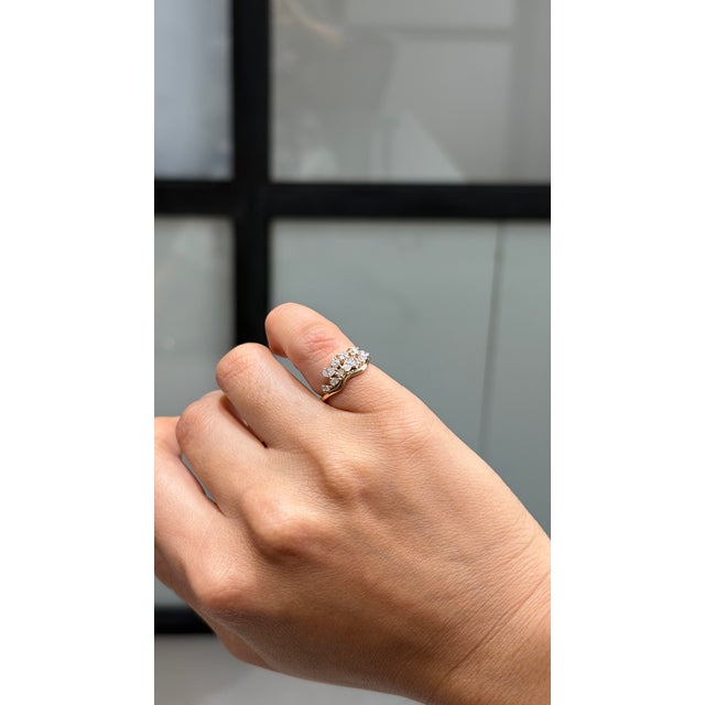 This cluster ring features 0.54 carats of certified natural mixed-cut diamonds, set in 14K yellow gold. in a graceful...