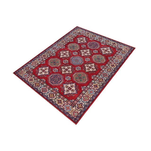 Enhance your home with this exquisite hand-knotted Kazak rug, crafted from fine hand-spun wool and dyed with all-natural...