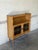 This distinctive bookcase features an open upper shelf beneath a beautifully scalloped top edge. The lower section offers...