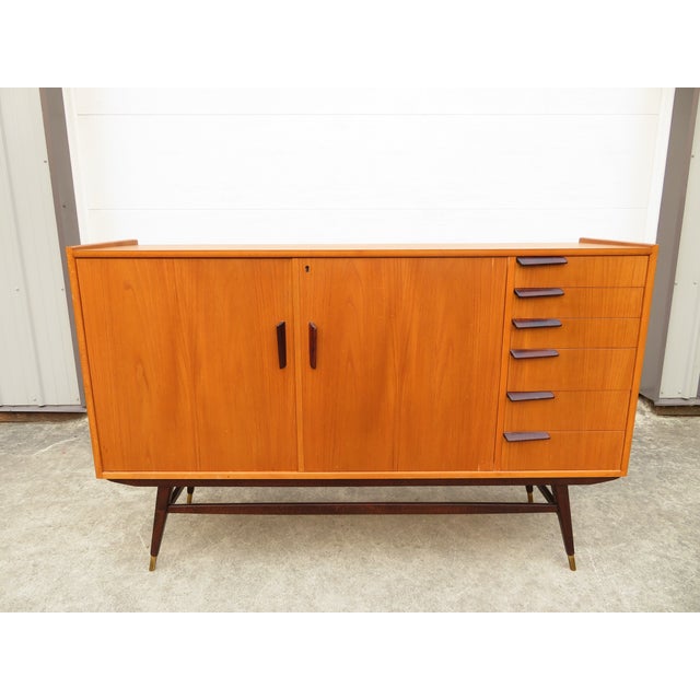Wonderful mid century modern teak Scandinavian 6 drawer sideboard with cabinet. Sleek sculpted wood drawer pulls and the...