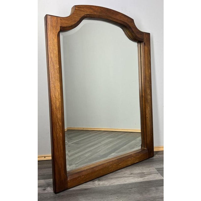 This elegant Vintage French mirror offers a warm and refined presence, crafted with a beautifully shaped oak frame and a...