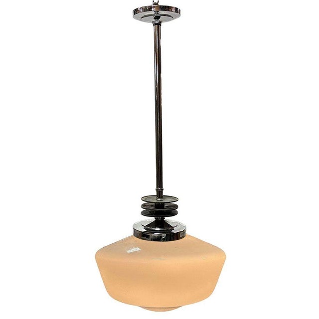 This 1930s Art Deco pendant light features a classic opal glass schoolhouse globe. It is paired with a Streamline Art Deco...