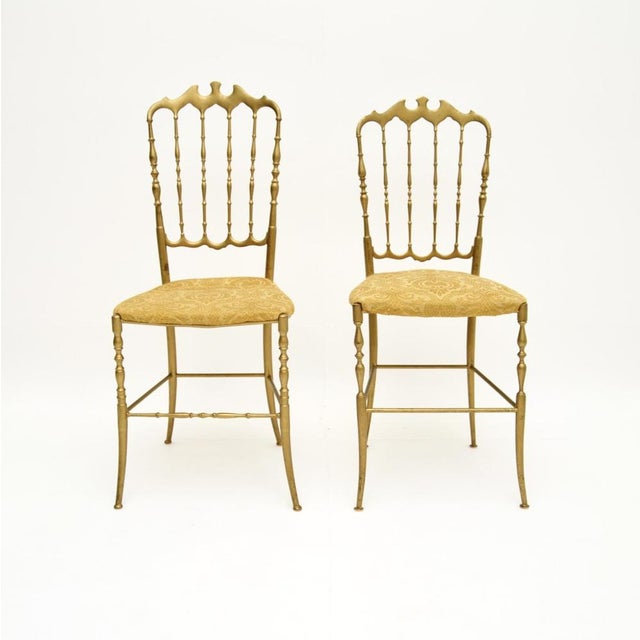 A gorgeous pair of vintage Italian Chiavari dining chairs in solid brass. They were made in Italy and date from around the...