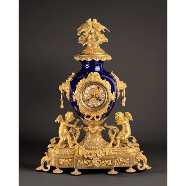 A magnificent napoleon iii period mantel clock, dating to around 1865–1875, crafted in deep bleu de sèvres porcelain and...