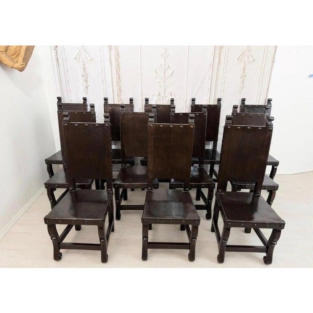 A truly rare and commanding find, this complete matched set of twelve Spanish Colonial Revival dining chairs brings...