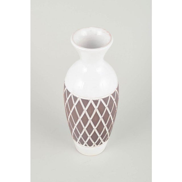 Gabriel, Sweden Ceramic vase, 1960/70s. Retro-styled tall vase in glazed faience with white top and base and a geometric...
