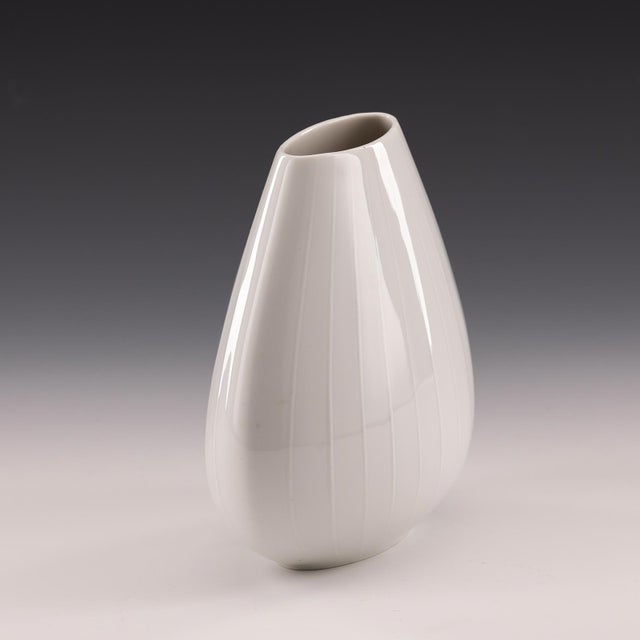 Offered is a timelessly simple porcelain vase from H&C Selb Bavaria Heinrich from Germany. This white vase has a bulbous,...