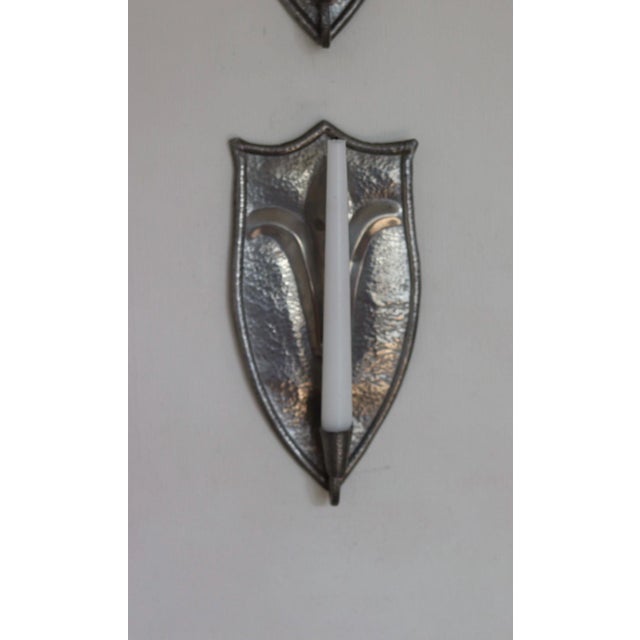 An amazing pair of mid century Swedish Pewter Sconces wall sconces the hammered texture and fleur-de-lis motif give them a...