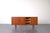 This teak sideboard was manufactured in Denmark in the 1960s. The furniture has five drawers, two sliding doors and one...