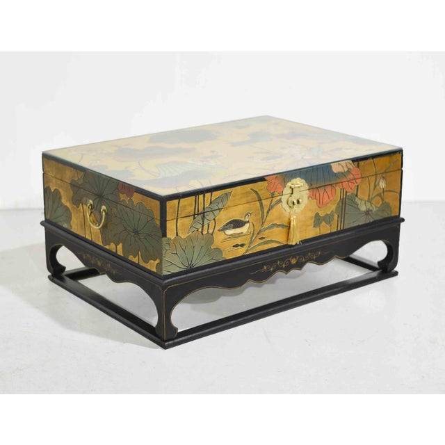 Artful, distinctive, and rich with character, this mid-century chinoiserie coffee table makes a bold decorative statement...