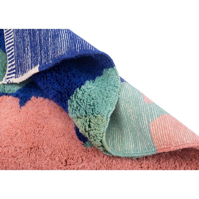 A rug that reads like a painted horizon — bold, sweeping fields of color meet and overlap in an abstract landscape of...