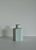 The vase has a very distinctive hexagonal body with chamfered corners and a short, collared bottle neck — a clean,...