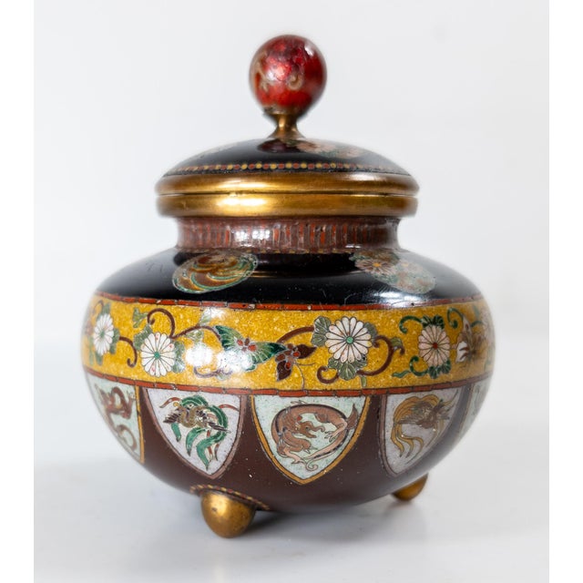 We are selling this small beautiful cloisonne enamel covered urn. This urn has great fine small decoration with flowers in...