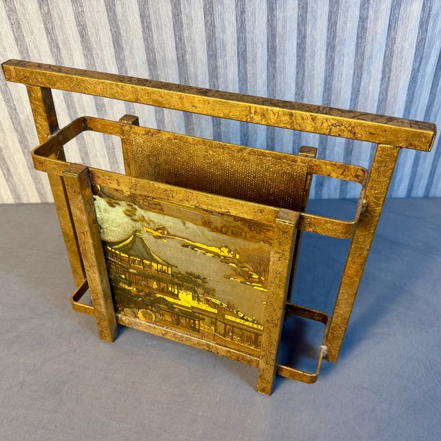 Hollywood Regency gold gilt Italian Magazine Rack with Gold Foil Chinoiserie Panels. Circa the 1960s it is in wonderful...