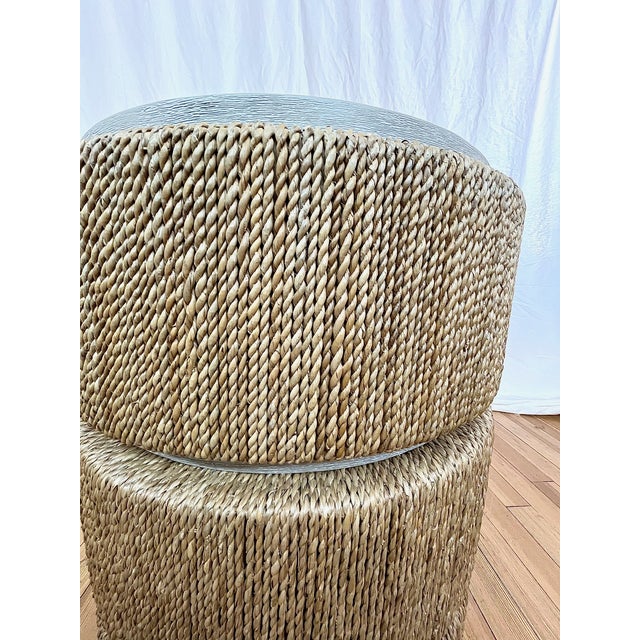 Round side table by Kravet crafted with a wood structure and wrapped in natural woven seagrass. The piece features a...